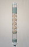 A spiral sounds midway microbeads rainstick stands 2 feet tall, and is displayed on a pedestal against a white background. The glass microbeads are blue and sparkle in the light. The rainstick tube is clear, and there is a visible wooden spiral down the middle of the instrument.