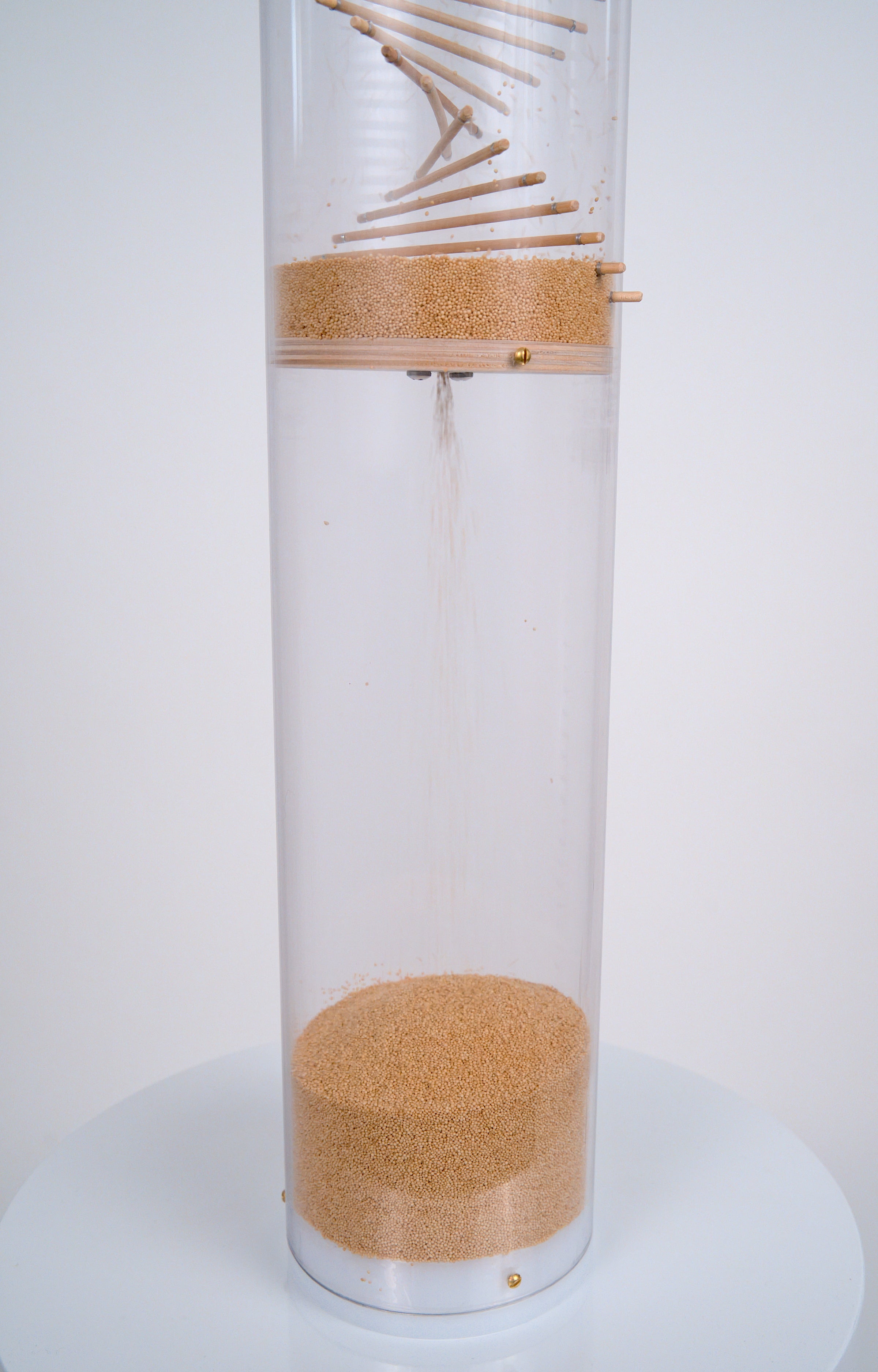 Millions of tiny tan amaranth seeds flow into the bottom reservoir of a clear tube that’s enclosed by a custom fit white cap at the bottom. The 20 minute XL Amaranth Rainstick by Rainstick Dreams produces a gentle long duration rain sound that is calming and soothing. It’s enjoyable for meditation or as a sleep aid.