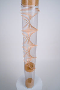 A view of the extra large amaranth Rainstick from the spiral looking down shows the tiny tan amaranth seed falling down through the beautiful wooden spiral helix that Rainstick Dreams is known for. This rainstick instrument has a long duration of 20 minutes.