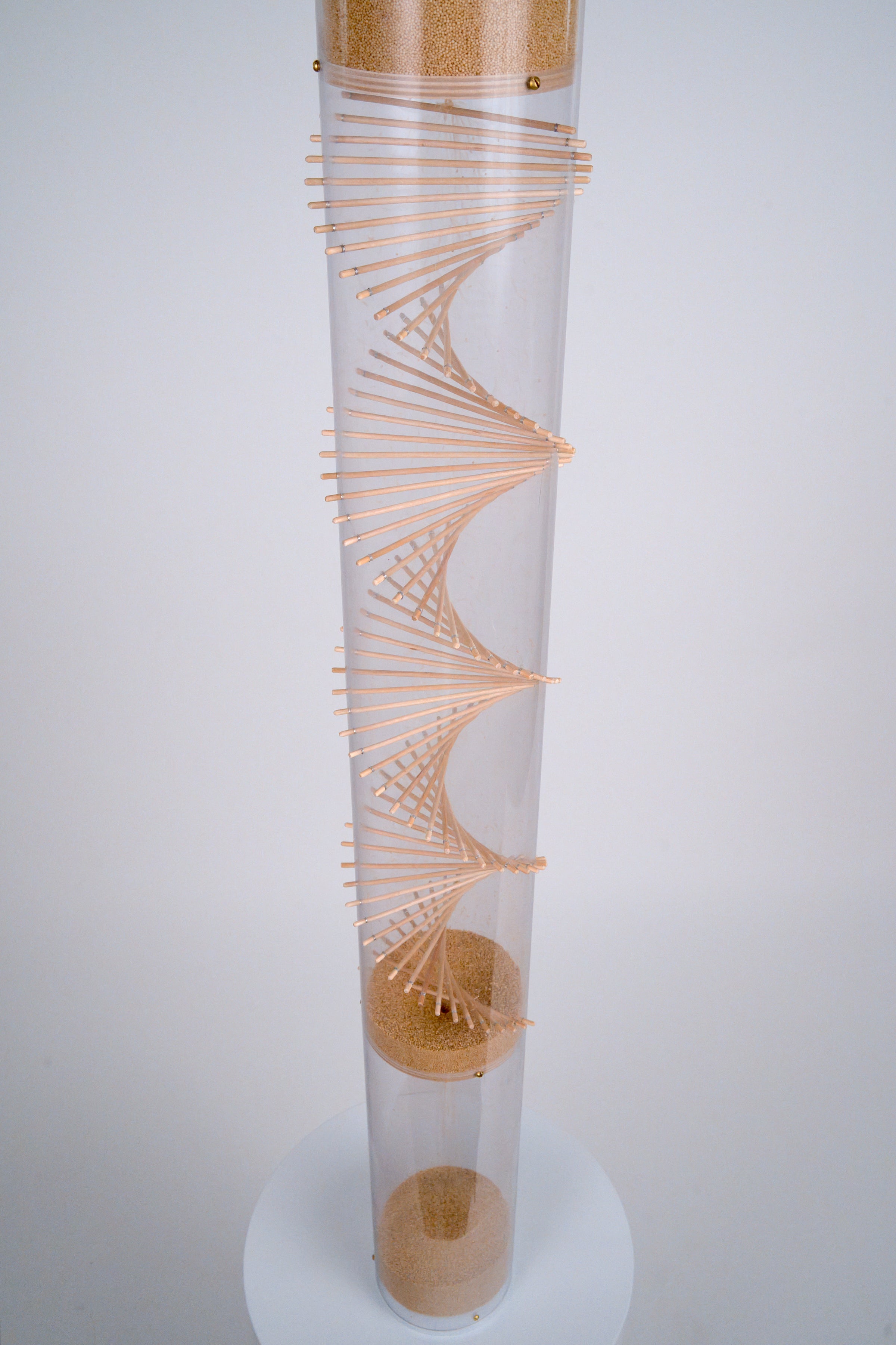 A view of the extra large amaranth Rainstick from the spiral looking down shows the tiny tan amaranth seed falling down through the beautiful wooden spiral helix that Rainstick Dreams is known for. This rainstick instrument has a long duration of 20 minutes.